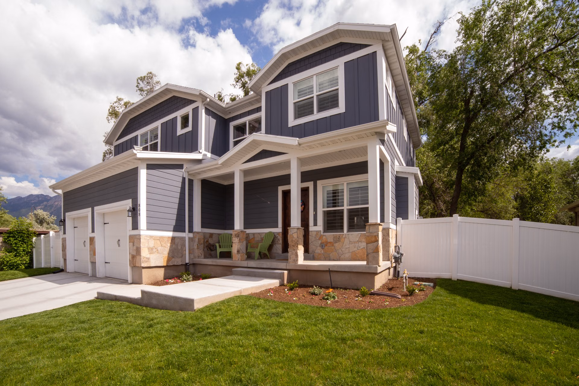 Two-story home with freshly painted blue-gray siding and crisp white trim