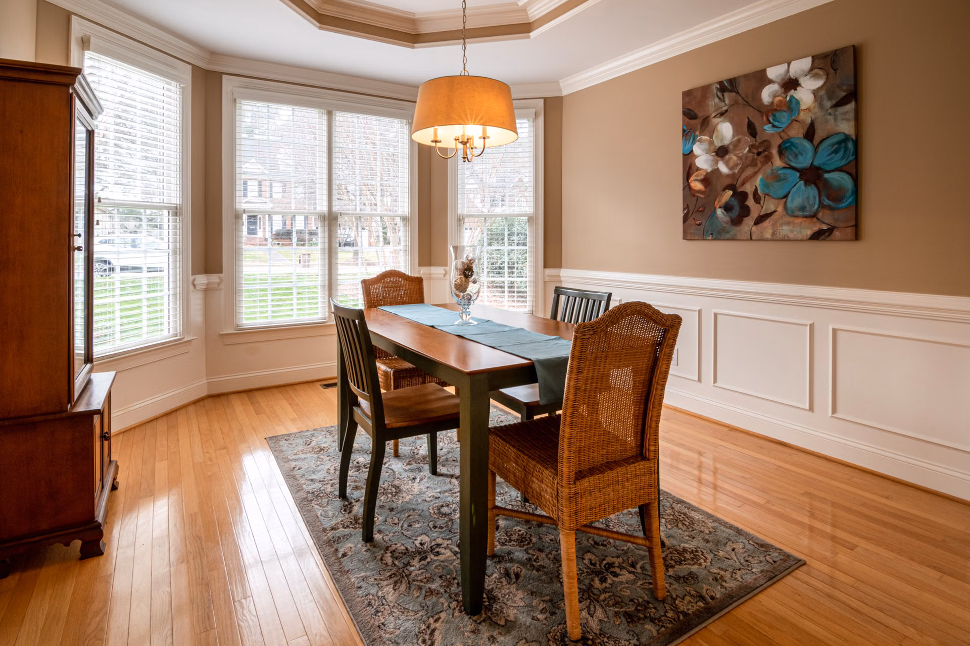 Dining room with painted white wainscoting and warm gray walls